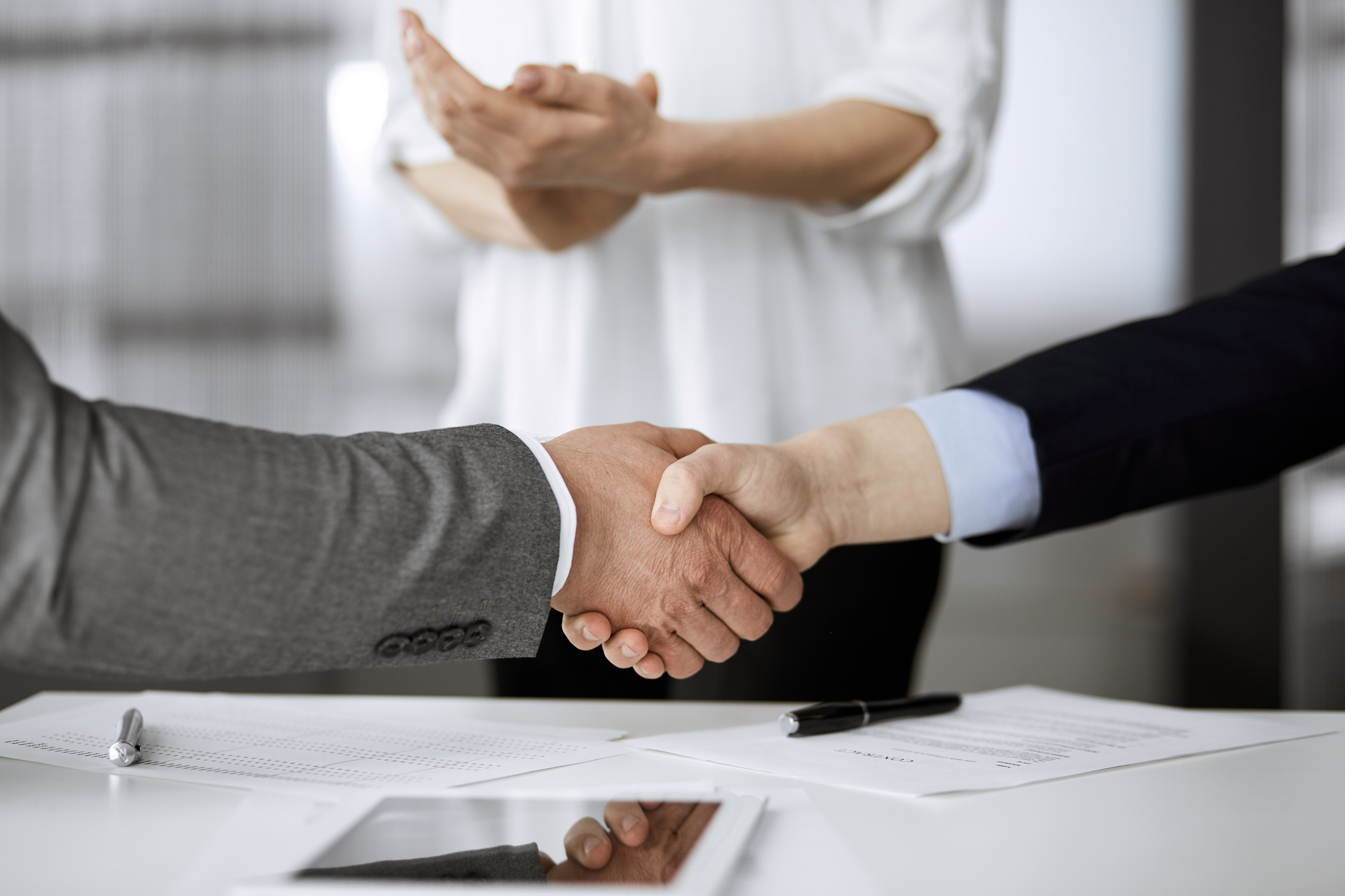 Business people shaking hands finishing contract signing, close-up. Business communication concept. Handshake and marketing.